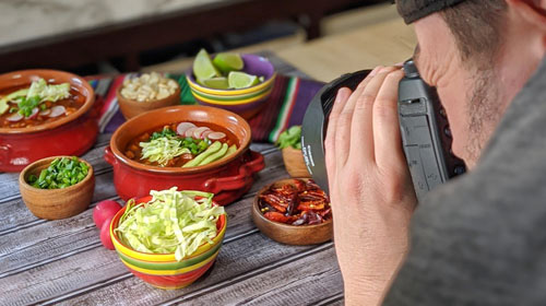 Behind-the-scenes view of Jay Olson on set capturing commercial food photography for a local client.